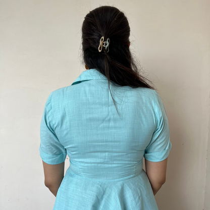 Person wearing a light blue dress 